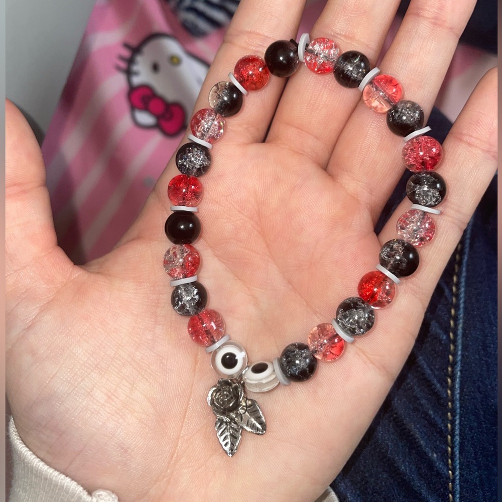 Handmade red and black glass beaded bracelet with silver rose charm